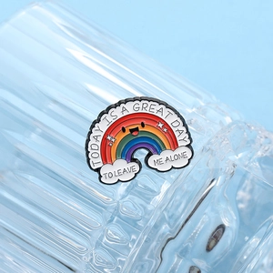 Close-up of rainbow enamel pin with text Today is a Great Day To Leave Me Alone