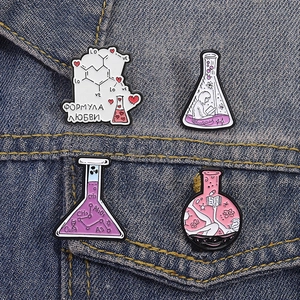 Creative chemistry enamel pins with laboratory flasks on a blue denim jacket