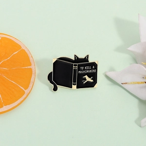 Cartoon black cat reading To Kill a Mockingbird book enamel brooch with gold-plated edges