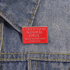 Funny red enamel brooch with English quote on blue denim jacket, stylish humor pin badge
