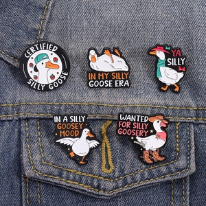 5-piece set of Silly Goose enamel pins on a denim jacket pocket featuring funny animal designs