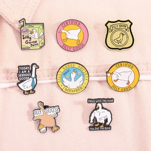 Detailed set of eight cute enamel pins featuring silly goose cartoons on pink fabric