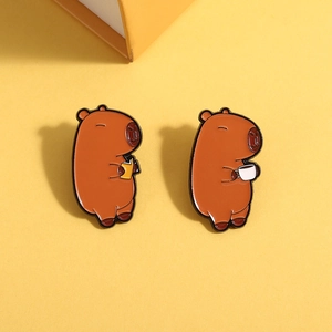 Cute Capybara enamel pins set featuring a reading and coffee-drinking animal cartoon design