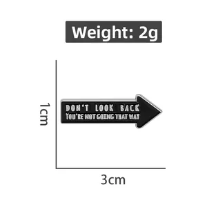Detailed view of 2g black enamel arrow pin badge with motivational text and size labels