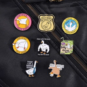 Detail of diverse silly goose enamel pins on a black leather jacket lapel collar