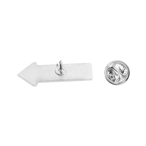 Detailed view of silver metal arrow brooch back with secure butterfly clutch closure