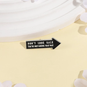 Arrow shaped enamel brooch with motivational quote Don't Look Back for clothing and bags