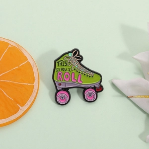 Green roller skate enamel pin with 'This Is How I Roll' text on light green background