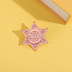 Detailed macro view of the rose gold sheriff star badge with relief engraving