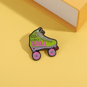 Green roller skate enamel brooch with This Is How I Roll slogan and pink wheels