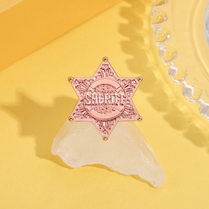 Rose gold sheriff star badge with relief texture on yellow background and crystal