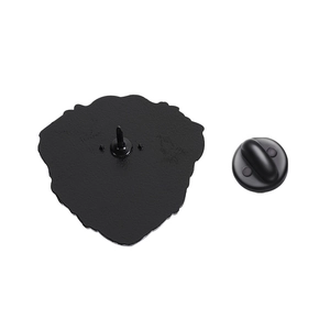 Detail of the black enamel pin back featuring a sharp metal needle and matte rubber clutch
