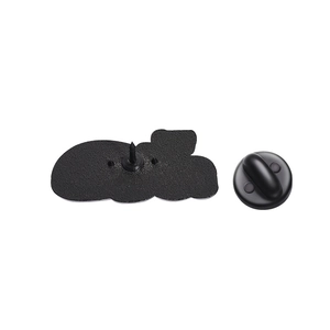 Macro view of the matte black metal backing and rubber clutch on the rock brooch