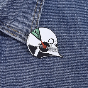 Macro shot of skull gauge enamel pin with HELPLESS text on a denim jacket lapel