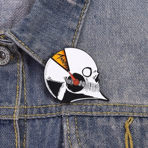 Creative rotating skull enamel pin with Annoyed meter design on denim jacket lapel