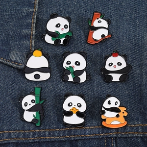 Detailed collection of eight cute panda enamel pins on a dark blue denim background