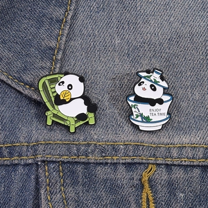 Cartoon panda enamel pins with tea cup and bamboo chair designs on denim fabric