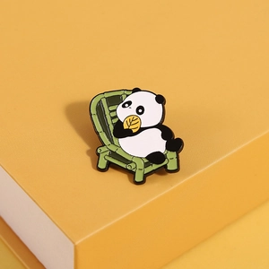 Detailed enamel finish of cute panda pin eating bamboo leaves on a yellow base