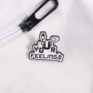 Detail of creative matchstick man enamel pin with YOUR FEELINGS text on white canvas