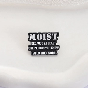 Funny black and white enamel pin with sarcastic quote about the word moist for clothing
