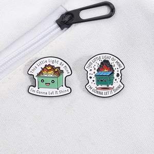 Dumpster fire enamel pins set featuring This Little Light Of Mine quote on white canvas