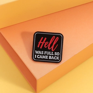 Detailed view of square enamel pin with Hell Was Full So I Came Back text on black base