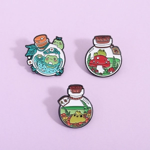 Three cute frog and mushroom enamel pins with star and plant motifs in green tones