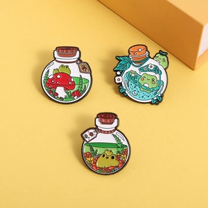 Three cartoon frog enamel pins in potion bottles with mushroom and moon designs