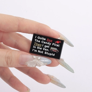 Macro shot of creative enamel pin with funny slogan and colorful van illustration