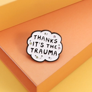 Enamel cloud brooch with 'THANKS IT'S THE TRAUMA' text and small stars