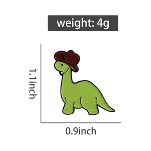 Detail of green dinosaur cowboy enamel pin showing 1.1x0.9 inch dimensions and 4g weight