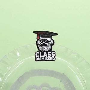 Detail of Karl Marx enamel pin with doctoral cap, sunglasses and Class Dismissed text