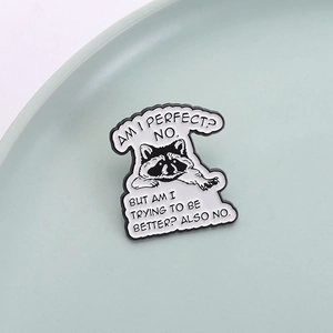 Funny raccoon enamel pin featuring a humorous quote on a minimalist ceramic tray
