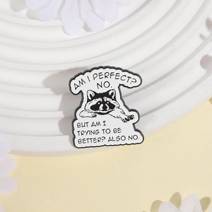 Creative raccoon enamel pin with humorous quote on a decorative white tray