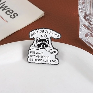 Funny raccoon enamel pin with sarcastic quote on white plate over leather background