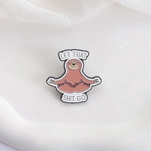Cute cartoon yoga sloth enamel pin in pink with Let That Shit Go text on white background