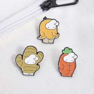 Detailed view of three cute rabbit enamel pins pinned on a white canvas fabric bag