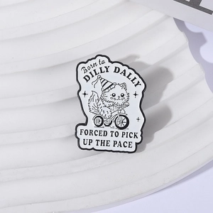 Cartoon white cat enamel pin on tricycle with humorous text on a textured display
