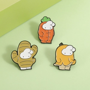 Cute cartoon carrot, ginger and banana enamel fruit pins set on a soft green background