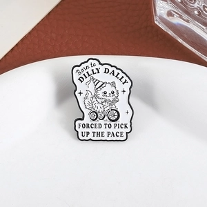 Cartoon cat riding a tricycle enamel pin with funny quote on a minimalist white tray