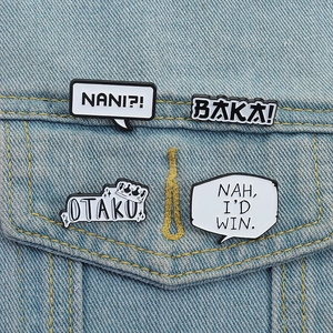 Anime enamel pin set with Baka and Otaku slogans pinned on a blue denim jacket pocket