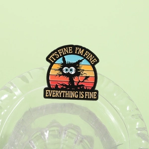 Macro detail of black cat enamel pin featuring sarcastic text against a soft green backdrop