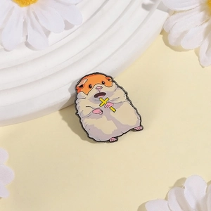 Cute cartoon hamster enamel pin with cross accessory on warm decorative background