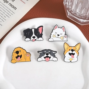 Set of five cute cartoon dog enamel pins including Corgi and Husky on a white plate