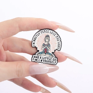 Detail of hand-held enamel pin with meditation lady and peace love and light quote