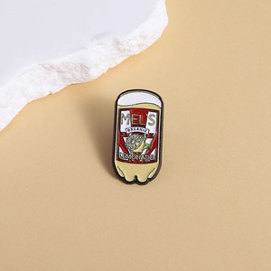 Detailed view of Mel's Organic Lemonade enamel pin with vintage red soda can design