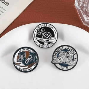 Vintage high-top canvas shoe enamel pins with NEVER REGRET text in a stylish flat lay set