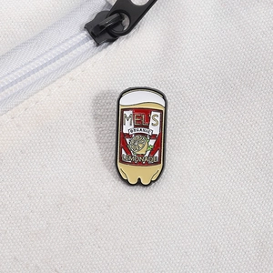 Close-up of Mel's Organic Lemonade enamel pin on white canvas with metallic zipper detail