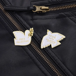 Set of two white dove enamel pins with gold trim and Palestine solidarity messages
