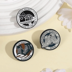 Close-up of three vintage canvas shoe enamel pins with NEVER REGRET text on white stand